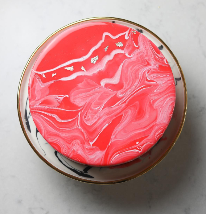 Crimson marbled mirror glaze cake with silver leaf