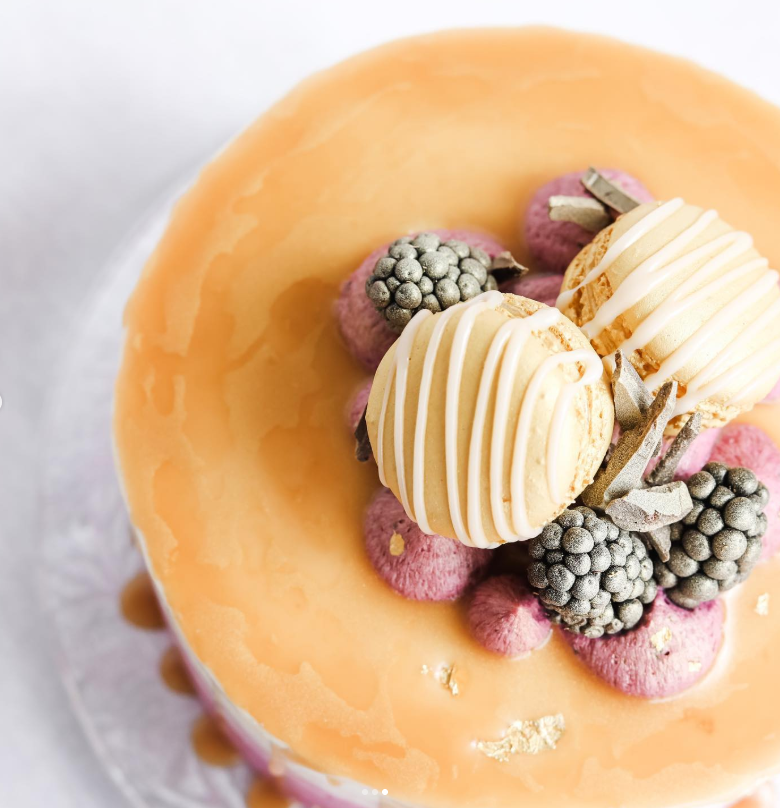 Overhead detail of caramel glaze with macarons and blackberries