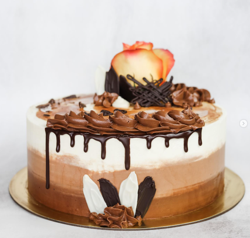 Chocolate ombré cake with dark ganache drip and piped rosettes