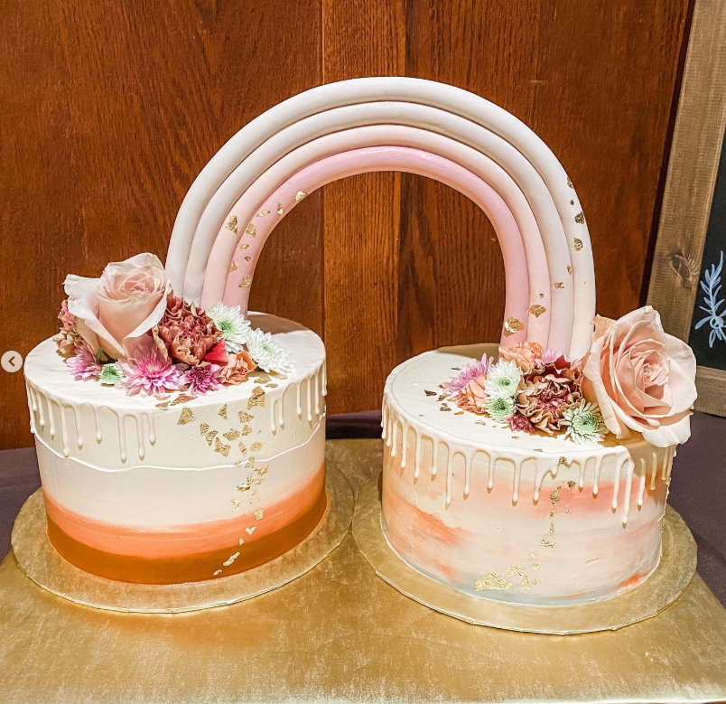 Pair of ombré cakes joined by a pastel fondant rainbow arch